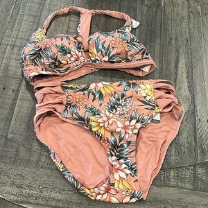 New with tags two piece floral bathing suit. Size large.